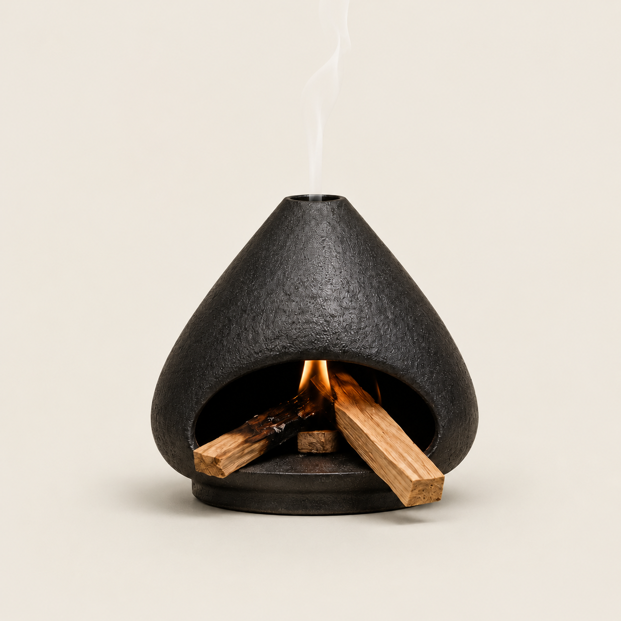 Black ceramic Palo Santo and sage burner with open hearth shape, burning wood, and smoke vent for indoor smudging rituals.