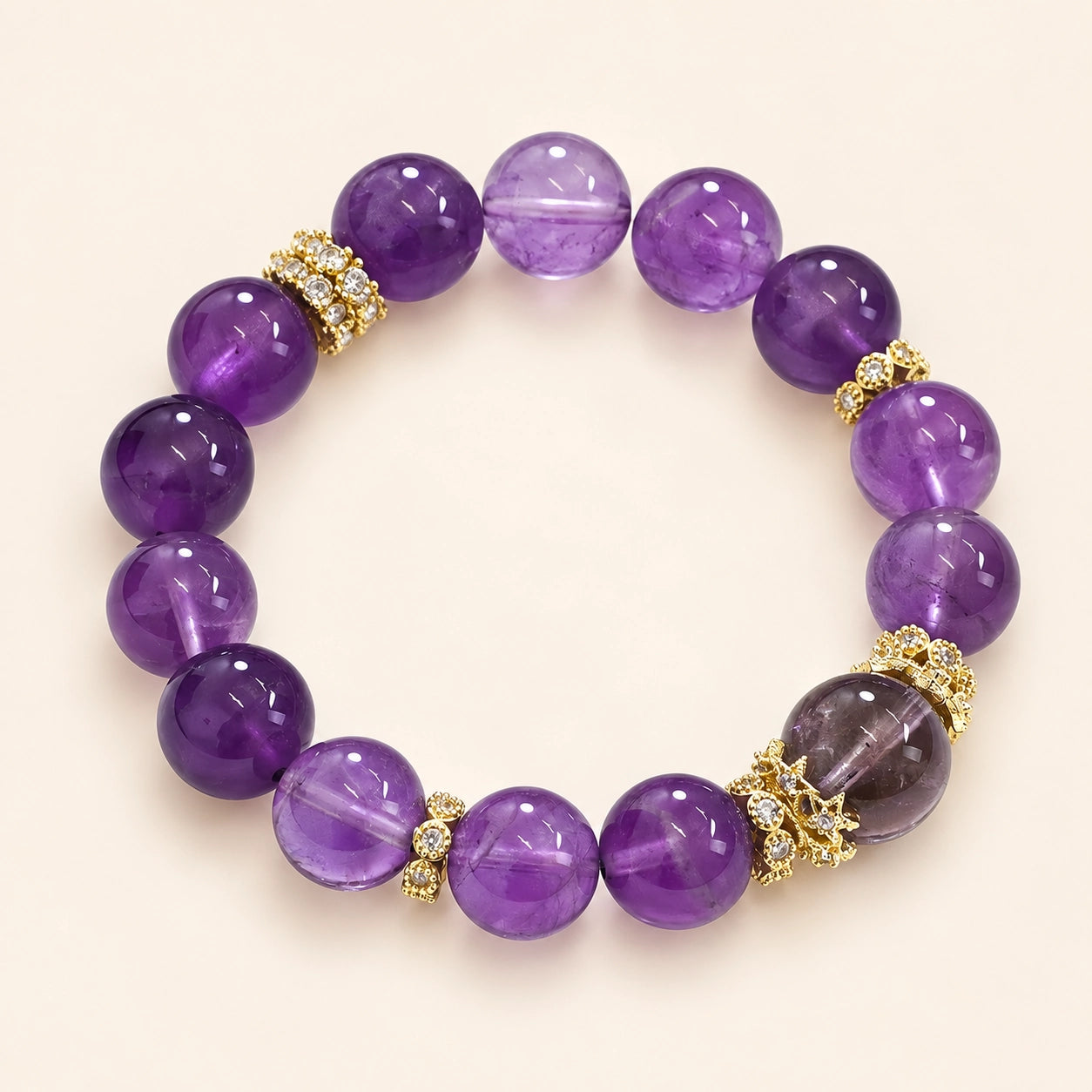 Top view of Uruguayan Amethyst Quartz Bracelet with 12 mm round purple amethyst beads, center stone and gold-tone spacers