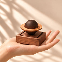 Saturn-shaped wooden aroma diffuser showing the circular wooden ring and square diffuser base