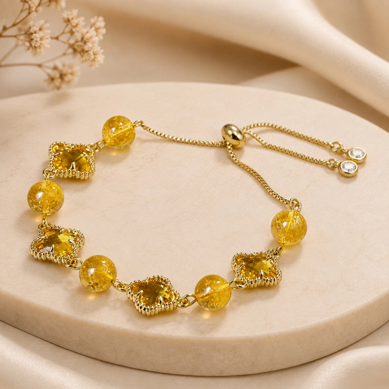 Natural citrine clover bracelet styled on a soft neutral background