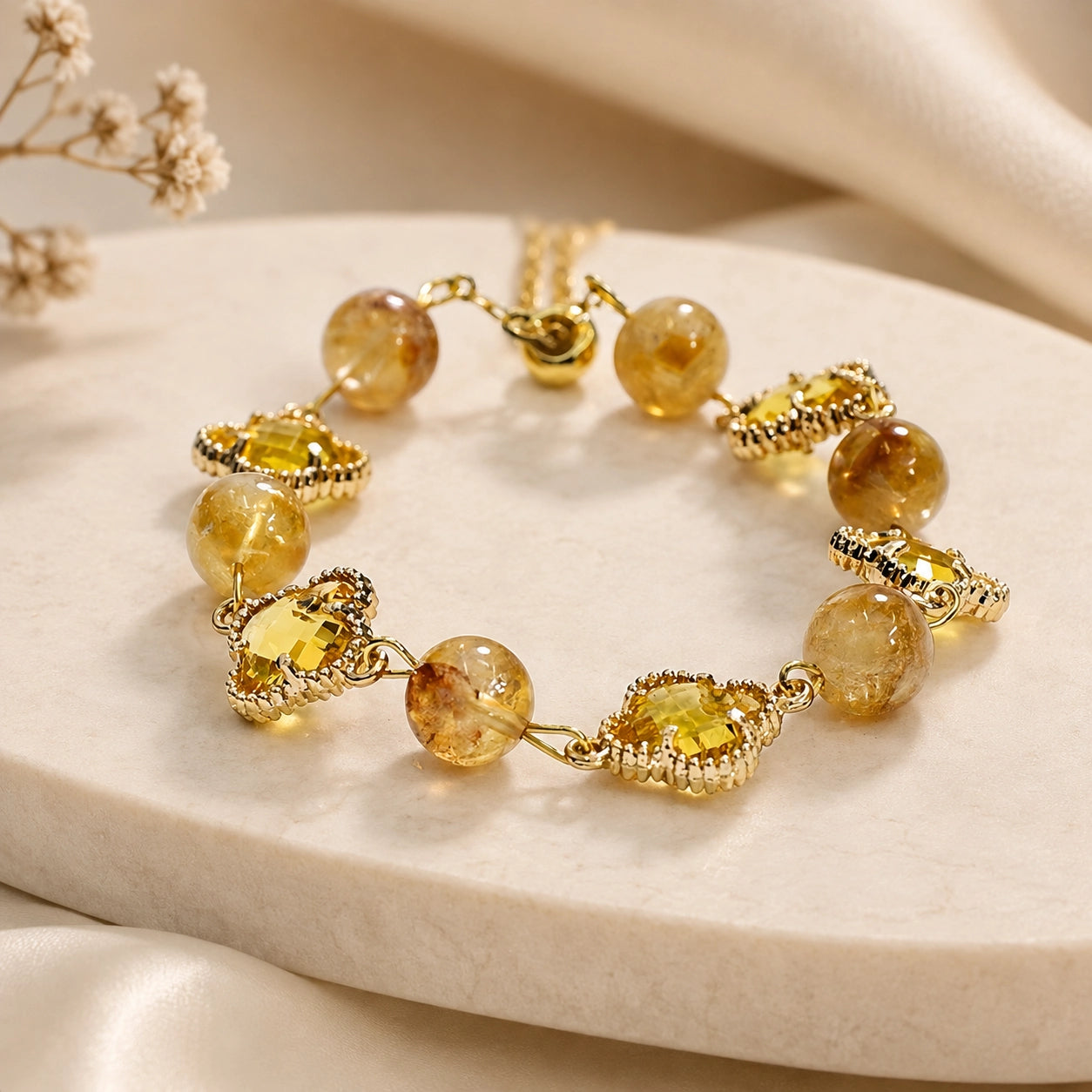 Close-up of natural citrine beads and gold four-leaf clover charms