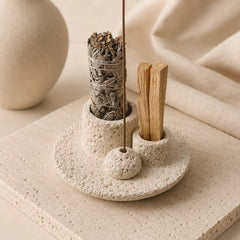 White concrete smudge bowl arranged with sage bundle, Palo Santo sticks and incense