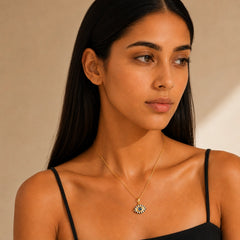 Woman wearing a white enamel evil eye pendant necklace with blue zircon and gold-plated chain