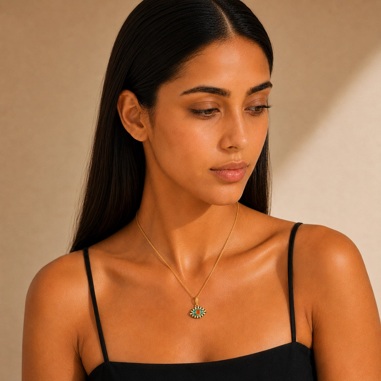 Woman wearing an aqua enamel evil eye pendant necklace with green zircon center stone