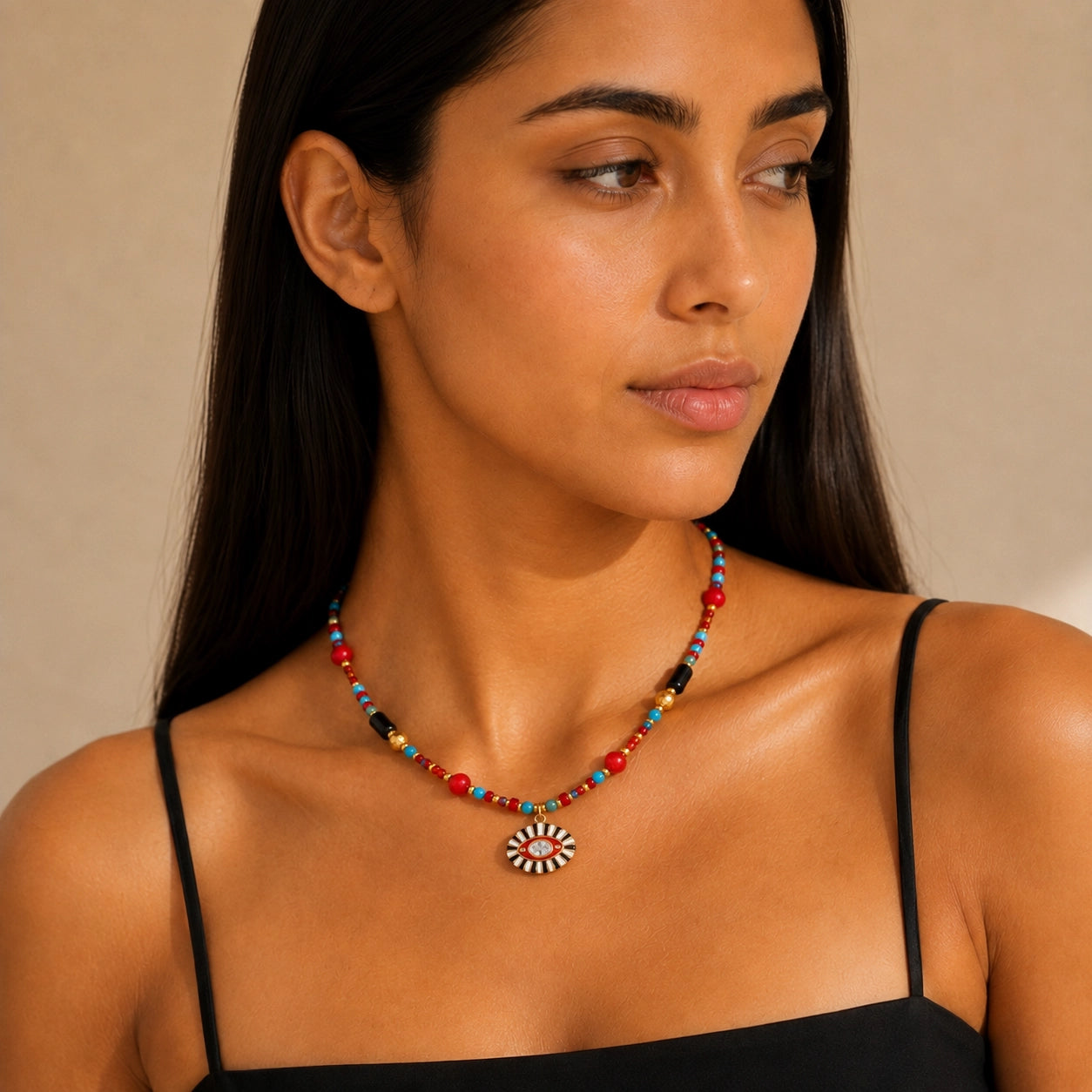 Model wearing a colorful Evil Eye gemstone necklace with red, turquoise and black beads