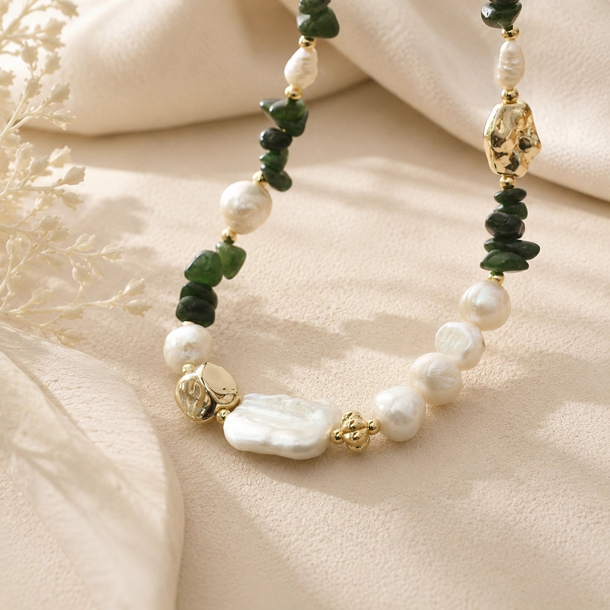 Close-up of green jade and freshwater pearl necklace with an organic pearl centerpiece