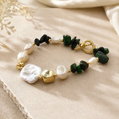 Close-up of green jade chip and freshwater pearl bracelet with gold-plated toggle clasp