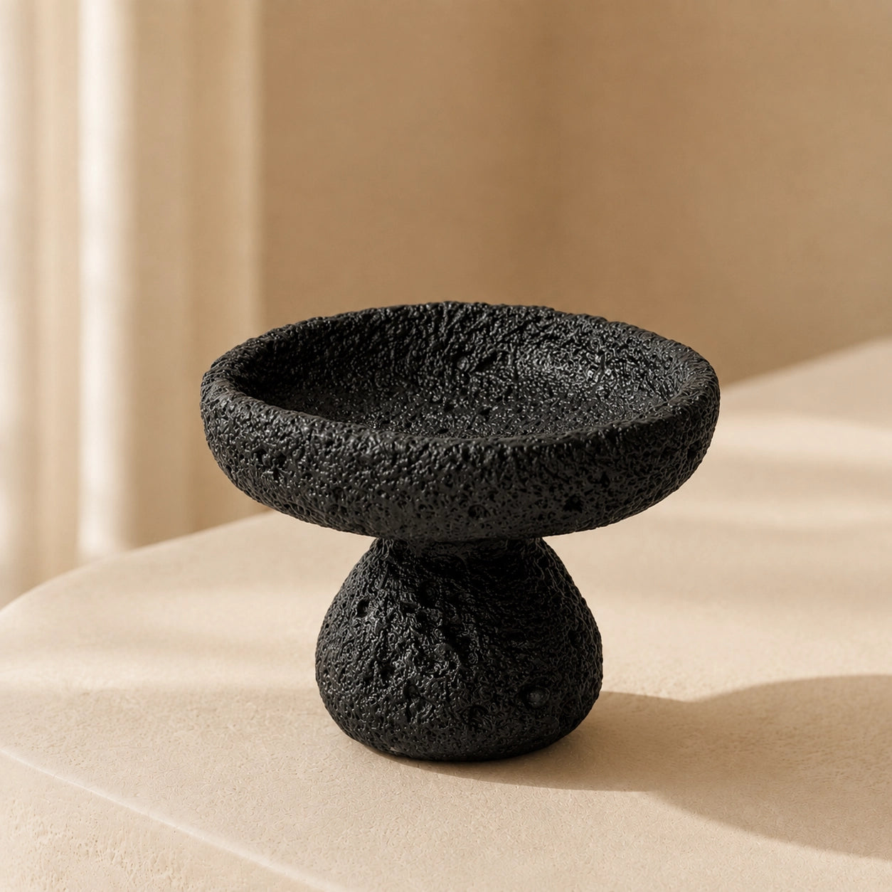 Black Nordic crystal cleansing bowl with sculptural pedestal and raw textured finish