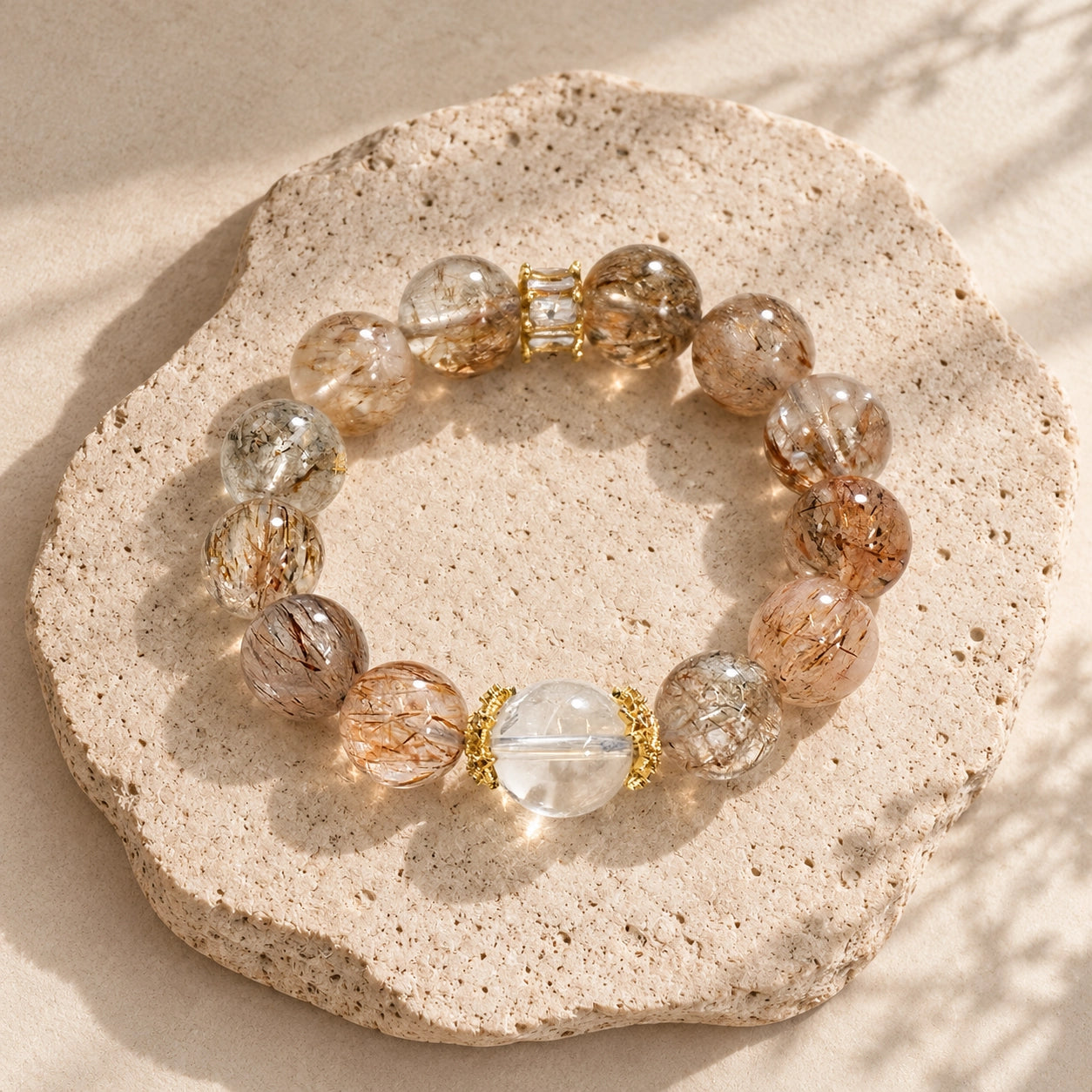Natural Black Golden Super Seven bracelet featuring a clear quartz focal bead and glossy gemstone beads.
