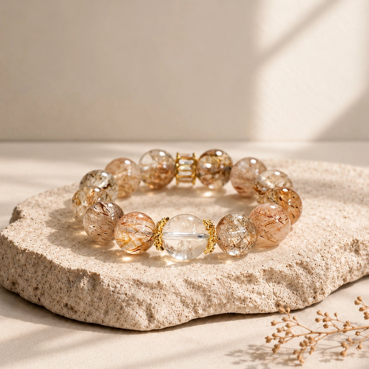 Clear quartz centerpiece and decorative gold-tone spacers in a Black Golden Super Seven beaded bracelet.