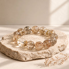 Polished Black Golden Super Seven crystal beads with fine golden-brown and smoky mineral inclusions.