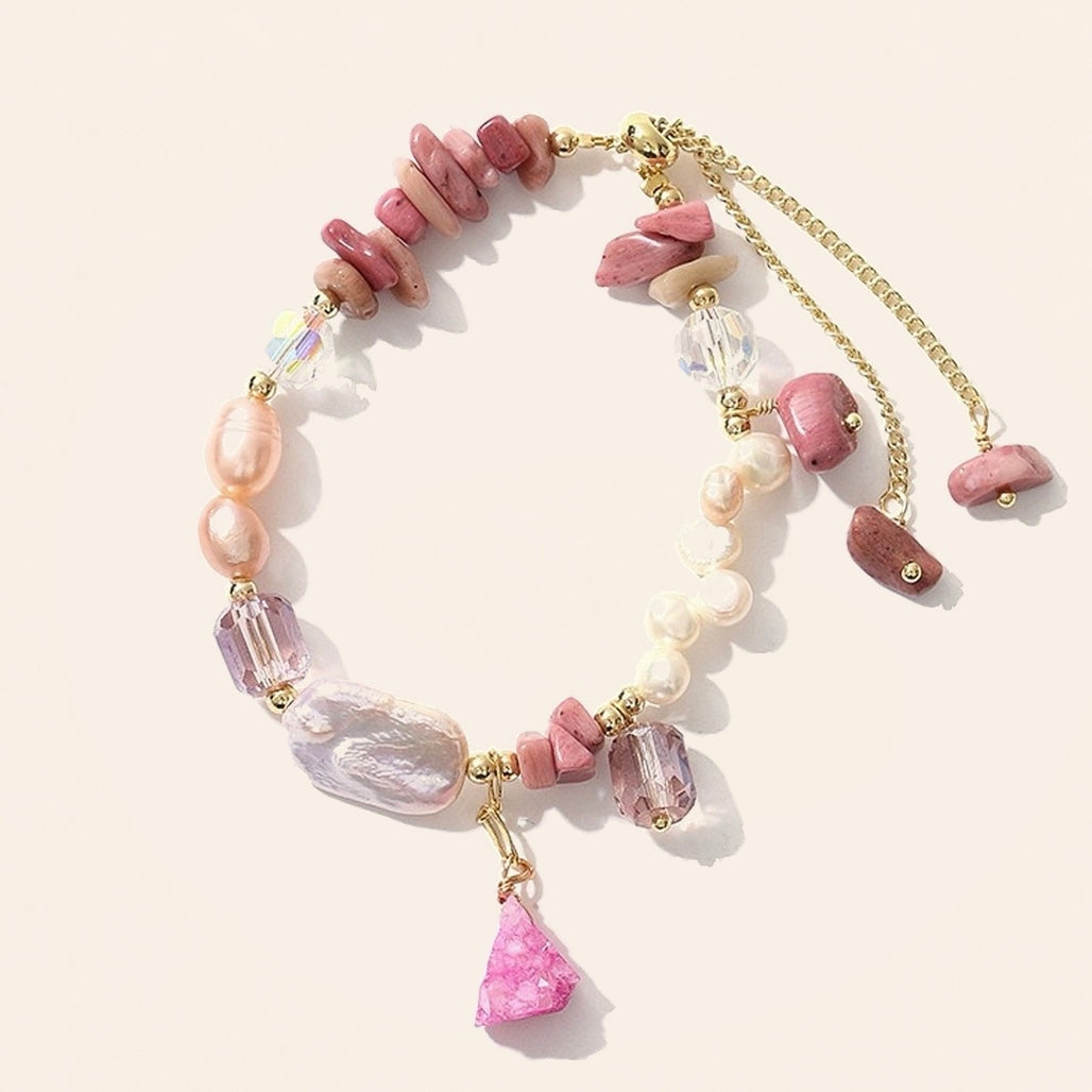 Rhodonite and baroque freshwater pearl bracelet with faceted purple accents, pink stone charm and gold-tone extender on cream