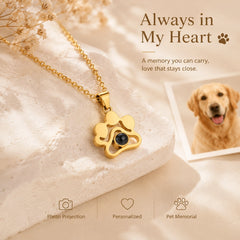 Gold personalized pet photo projection necklace displayed beside a cherished dog photograph