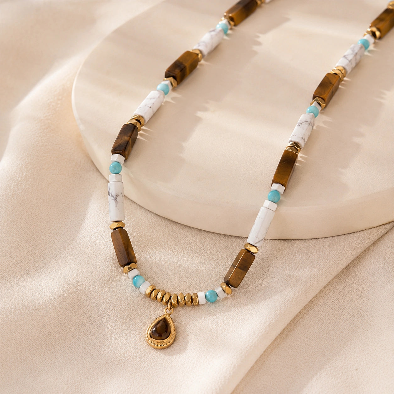 Healing crystal necklace displayed with turquoise and tiger eye inspired stones for grounding and clarity