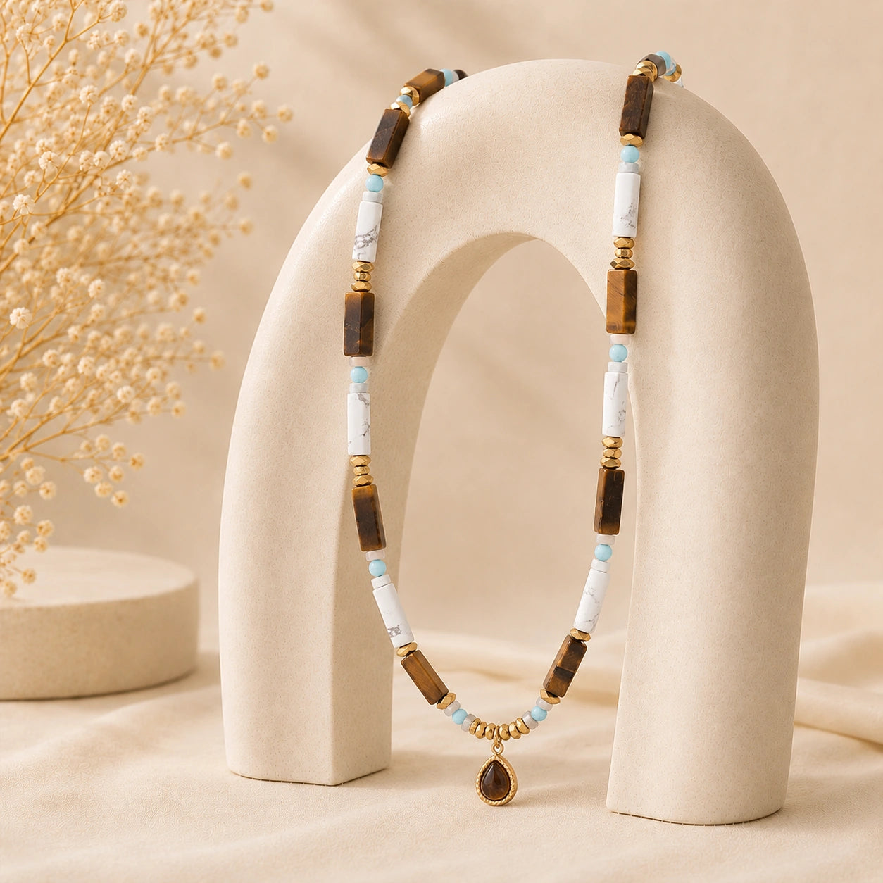 Close up of boho healing crystal necklace with natural stone beads and symbolic pendant details