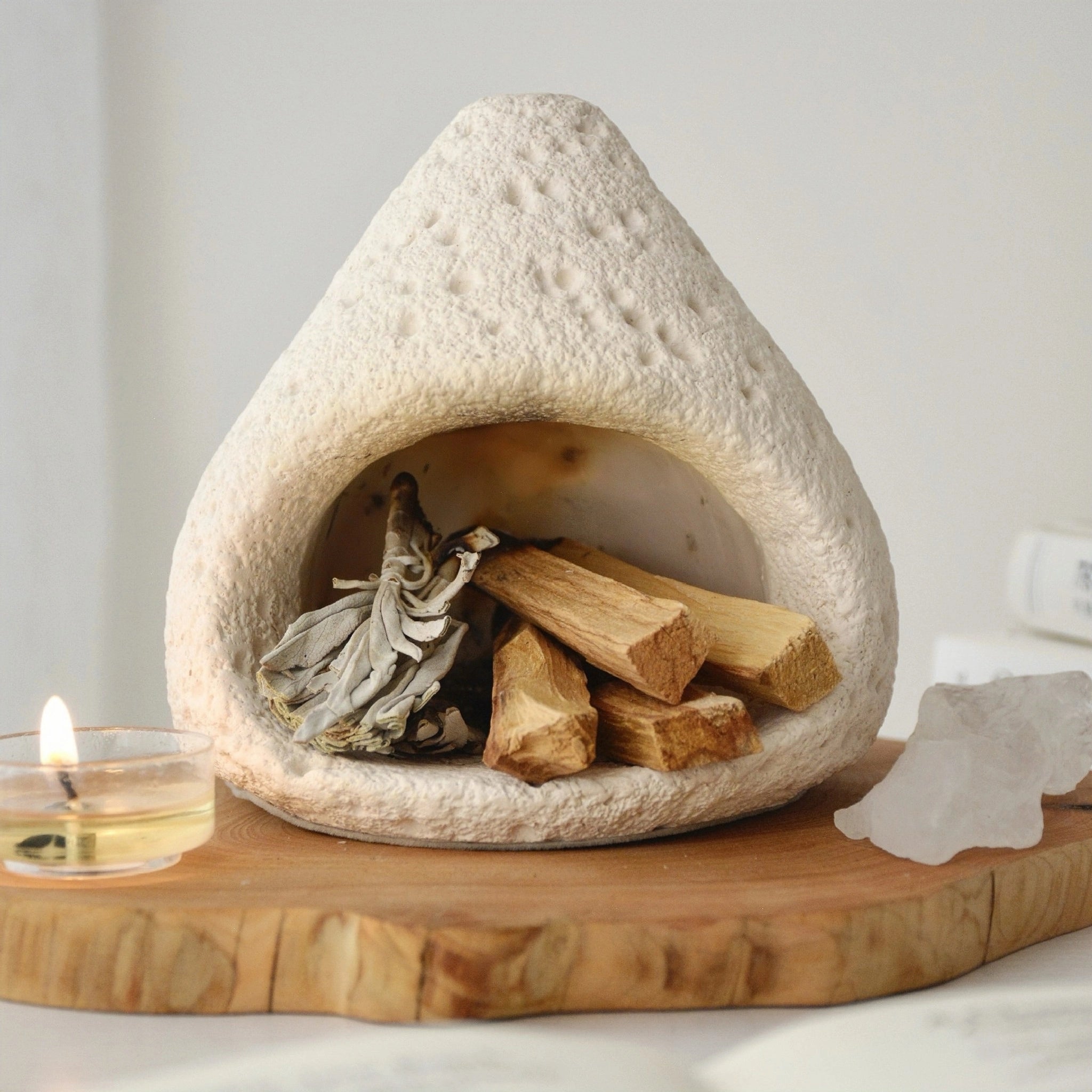 Ceramic incense and smudging burner displayed with Palo Santo sticks and sage bundles.