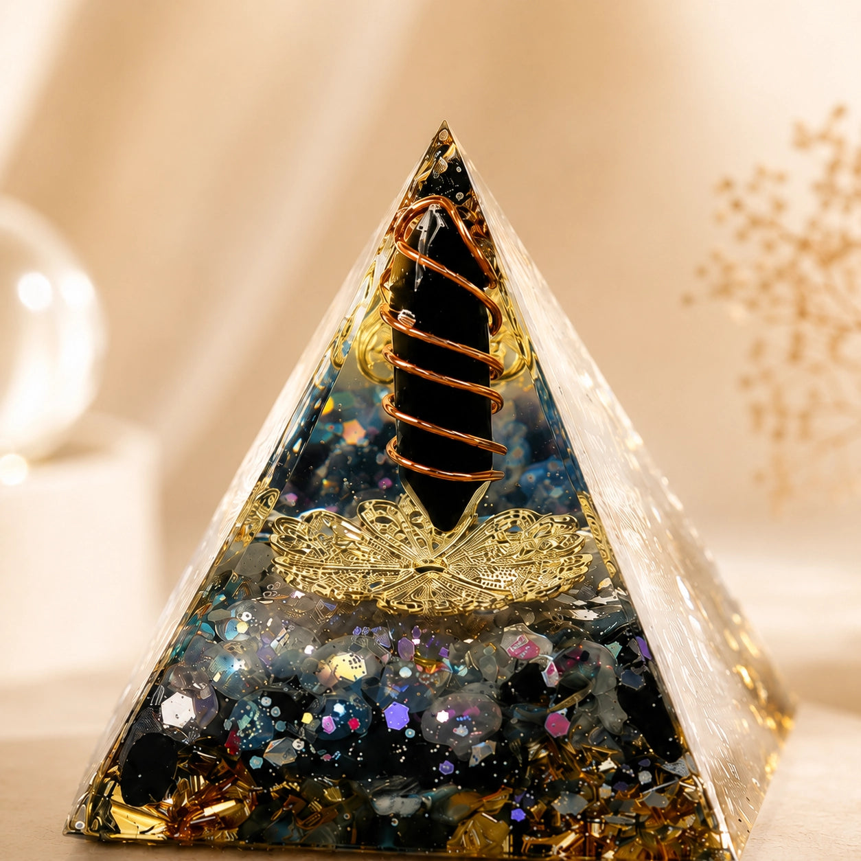 Close-up of a protection and energy shield orgonite pyramid with obsidian point, labradorite chips and copper coil details