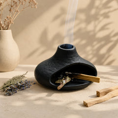 Black ceramic Palo Santo and sage burner styled with cedar, lavender and cleansing botanicals