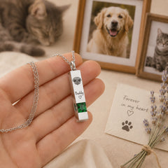 Actual size of a personalized pet nose print urn necklace displayed in a person’s hand