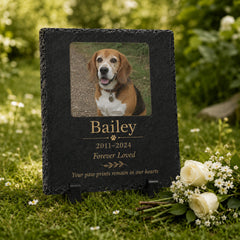 Personalized dog grave marker with photo, name, dates and display stand in a garden setting