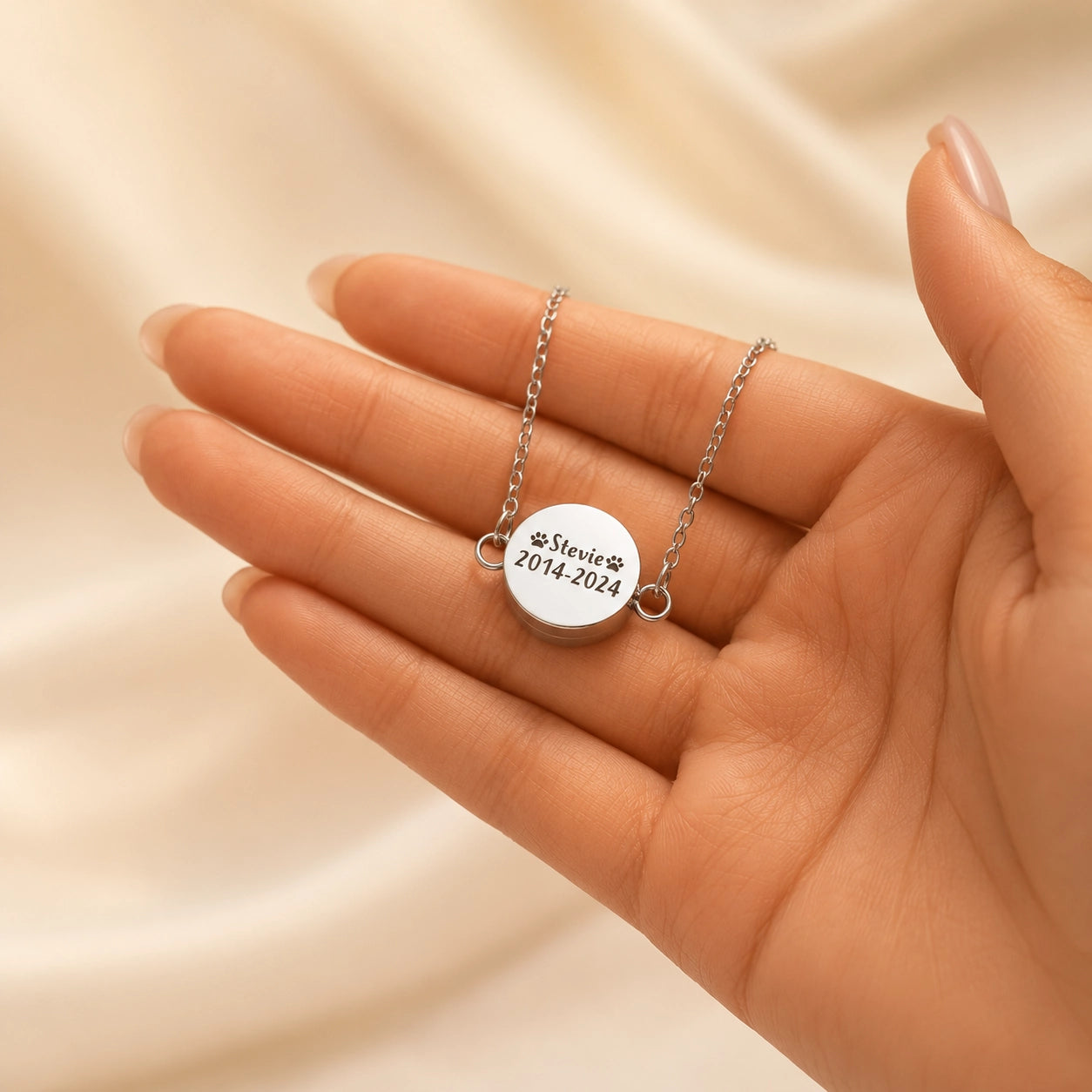 silver pet memorial bracelet with custom name and date engraving held in hand