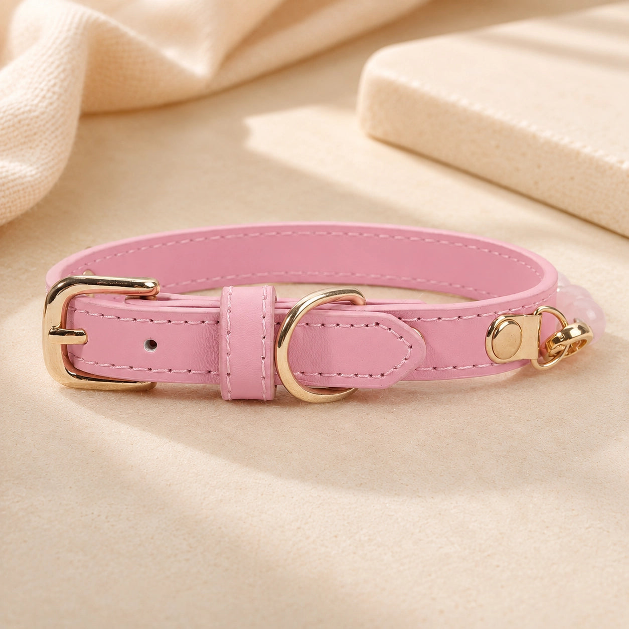 Adjustable pink PU leather dog collar with polished gold-tone buckle and D-ring