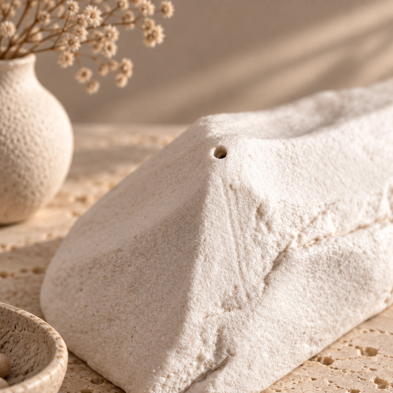 Close-up of the handmade white ceramic mountain incense holder showing its textured surface and incense opening
