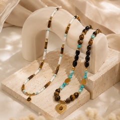 Healing crystal necklace styled in a soft boho setting with natural stones and layered design