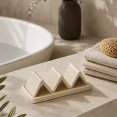 Natural sandstone soap dish beside bathtub with wave-shaped holder for spa bathroom
