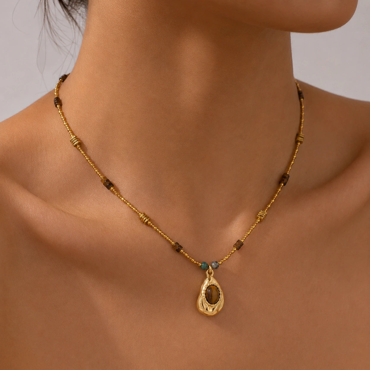 Close Up of Tiger’s Eye Pendant Necklace on Model