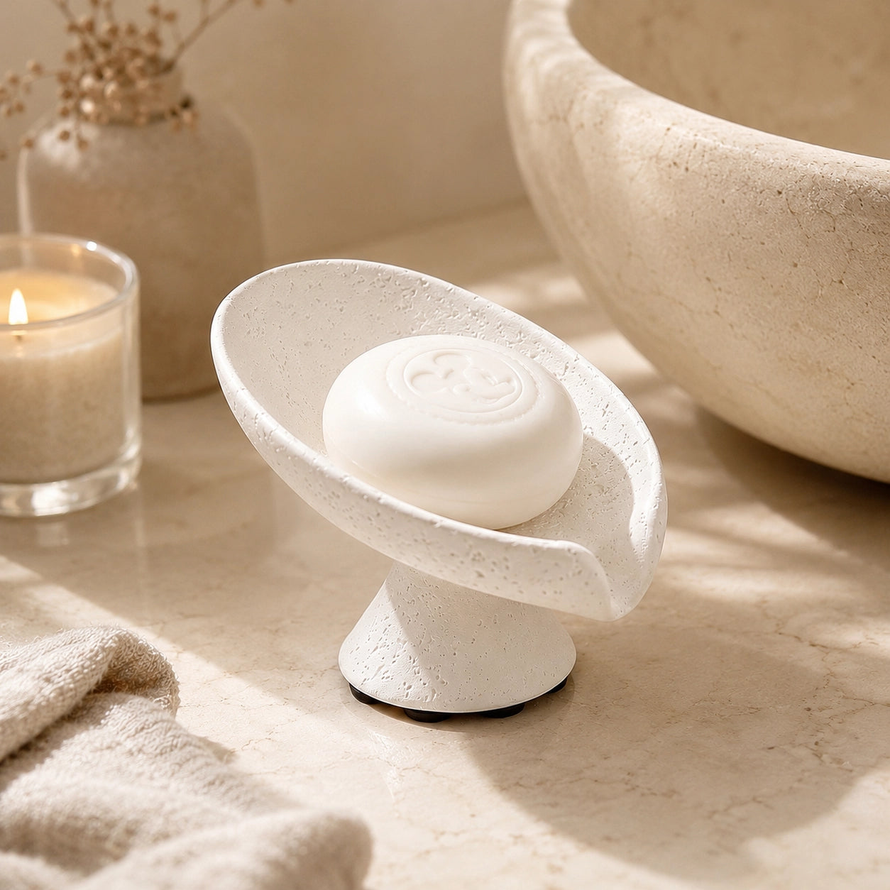 White Wabi Sabi soap dish with soap in a calm home spa bathroom setting.